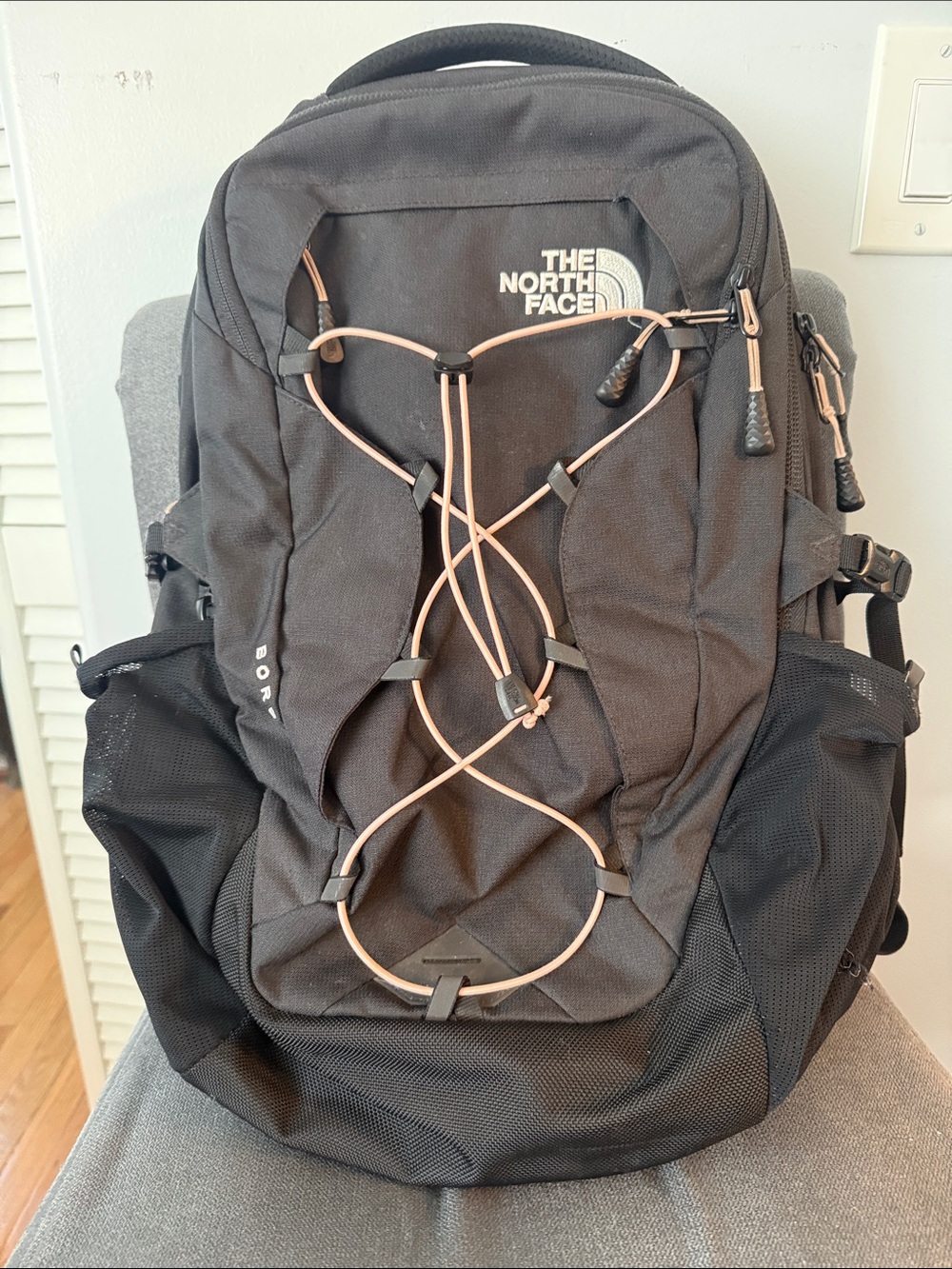 The North FaceBorealis Black Backpack with light pink Bungee Cord
